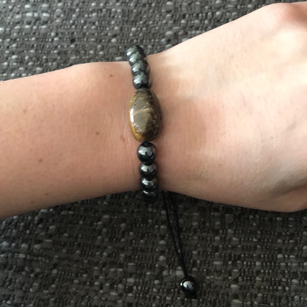 Adjustable hematite and polished stone bracelet.